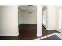 Open-concept dining room featuring dark floors, modern lighting, and stylish archways at 10770 Glenhurst Pass, Duluth, GA 30097