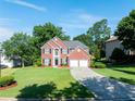 Charming two-story brick home with a well-manicured lawn and a two-car garage at 10770 Glenhurst Pass, Duluth, GA 30097