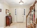 Bright foyer featuring neutral decor and staircase with wooden banister at 1386 Sheffield Glen Ne Way, Atlanta, GA 30329