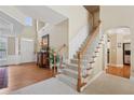 Bright foyer with hardwood floors and a staircase leading to the upper level at 25 Hampreston Court Ct, Johns Creek, GA 30022