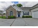 Close up of front facade showing stone veneer, blue front door, and garage at 3573 Plantation Pl, Loganville, GA 30052