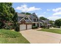 Inviting two-story home featuring a two-car garage and well-kept front yard at 7090 River Island Cir, Buford, GA 30518