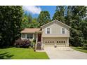 Charming two-story home with attached two-car garage and a red front door surrounded by green trees at 177 Rustin Dr, Dallas, GA 30157