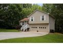 Charming two-story home featuring an attached two-car garage and a well maintained yard surrounded by trees at 177 Rustin Dr, Dallas, GA 30157