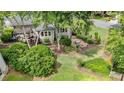 Aerial view of landscaped backyard featuring firepit, patio and mature trees at 295 Sagamore Nw Cv, Sugar Hill, GA 30518