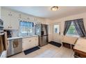 Bright kitchen with stainless steel appliances, white cabinets, and a functional layout at 965 Grimes Bridge Rd, Roswell, GA 30075