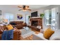 Cozy living room featuring a brick fireplace, hardwood floors, and comfortable leather seating at 965 Grimes Bridge Rd, Roswell, GA 30075