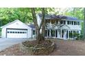 Inviting two-story white home with well-maintained landscaping and a brick driveway at 3873 Rains Ne Ct, Brookhaven, GA 30319