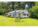 View of the front of the home, featuring a chimney and tidy landscaping at 1054 Hillcrest Se Dr, Atlanta, GA 30316