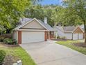 Inviting home with brick accents, a spacious driveway and attached two car garage at 172 Stoneforest Dr, Woodstock, GA 30189