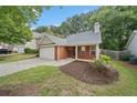 Beautiful brick home with a two car garage and well maintained landscaping at 172 Stoneforest Dr, Woodstock, GA 30189