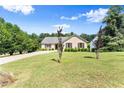 Attractive brick home featuring a green lawn and driveway with green foliage at 3260 Governors Court Ct, Duluth, GA 30096