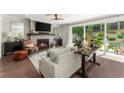 Open living room with a fireplace, hardwood floors, and a sliding glass door to the outdoor patio at 109 Bellehaven Dr, Woodstock, GA 30188