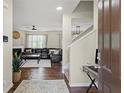 View of entryway, hardwood floors, leading to the living room with a fireplace at 8553 Braylen Manor Dr, Douglasville, GA 30134