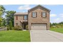 Inviting two-story brick home with a well-manicured lawn and a spacious driveway at 8553 Braylen Manor Dr, Douglasville, GA 30134