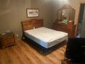 Bedroom with a wooden bed frame, neutral walls, and hardwood floors at 245 Jesse Mccollum Dr, Canton, GA 30114