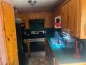 Functional kitchen featuring wooden cabinets and black appliances, ready for your personal touch at 245 Jesse Mccollum Dr, Canton, GA 30114