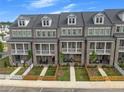 Overhead shot of townhomes with brick facades, balconies, private yard, picket fences and walkways at 579 Brashy St, Woodstock, GA 30188