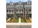 Three townhomes with brick facades, private yards, picket fences, and inviting porches and balconies at 579 Brashy St, Woodstock, GA 30188