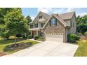 Beautiful two-story home featuring a brick facade, well-kept lawn, and attached two-car garage in a lovely suburban setting at 4345 Idlewood Dr, Cumming, GA 30040