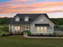 Beautiful modern farmhouse during sunset featuring a well-manicured lawn and lovely curb appeal at 4720 Down Setting Rd, Cumming, GA 30028