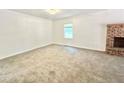 Large bedroom featuring neutral walls, carpeted floors, and a brick fireplace at 5968 Hilltop Dr, Douglasville, GA 30135