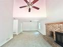 Bright living room featuring carpeted floors, a brick fireplace, and a ceiling fan at 5968 Hilltop Dr, Douglasville, GA 30135