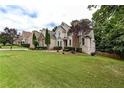 Charming two-story home featuring a lush lawn, mature trees, and well-maintained landscaping at 1360 Mount Mickinley Dr, Grayson, GA 30017