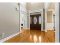 Inviting foyer showcasing gleaming hardwood floors and a striking front door with decorative glass inserts at 1360 Mount Mickinley Dr, Grayson, GA 30017
