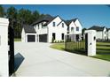 Elegant two-story home with a long driveway and a manicured lawn at 3207 Bold Springs Rd, Dacula, GA 30019