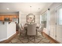 Bright dining area with modern light fixture, stylish rug, and view to the kitchen area at 429 Mountain View Ln, Woodstock, GA 30188