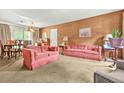 Spacious living area with ample seating, a dining area, and a sliding glass door at 2454 Fairway Sw Cir, Atlanta, GA 30331