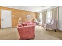 Inviting living room with plush seating, textured walls, and large windows at 2454 Fairway Sw Cir, Atlanta, GA 30331