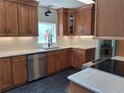Modern kitchen featuring stainless steel appliances, stone countertops, and wood cabinets at 1131 Steeple Run, Lawrenceville, GA 30043