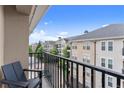 Cozy balcony with a chair overlooking the complex with views of the neighboring buildings and trees at 1850 Cotillion Dr Unit 3416, Atlanta, GA 30338