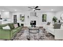 Bright living room featuring modern furniture, hardwood floors, and a decorative fireplace with white painted brick at 4669 Dunover Cir, Atlanta, GA 30360