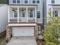 This beautiful home boasts a covered front porch, stone accents, and a convenient two-car garage at 499 Bishop Ln, Woodstock, GA 30188