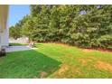 Lush green backyard featuring a swing and patio area with lawn at 3419 Allie Dr, Snellville, GA 30039