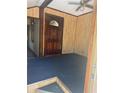 Traditional home entryway with a dark wood door, textured walls, and blue carpeting at 718 South Ave, Forest Park, GA 30297