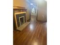 Living room featuring hardwood floors, a decorative fireplace, and neutral-toned walls at 718 South Ave, Forest Park, GA 30297