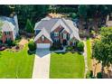 Spacious brick home with a pristine lawn and mature tree coverage at 830 Club Chase Ct, Roswell, GA 30076