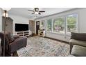 Inviting living room featuring a large window, hardwood floors, and a comfortable sofa at 2432 Saint Patrick Se St, Atlanta, GA 30317