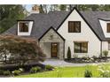 Charming front entrance with stone accents and a professionally landscaped yard at 1155 Peachtree Battle Nw Ave, Atlanta, GA 30327
