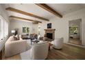 Spacious living room featuring hardwood floors, wood beams, fireplace and abundant natural light at 1155 Peachtree Battle Nw Ave, Atlanta, GA 30327