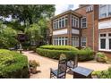 Charming brick building with outdoor seating surrounded by manicured landscaping at 737 Barnett Ne St # B6, Atlanta, GA 30306