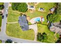Aerial view of a well-maintained property with a beautiful pool and lush green lawn in a serene neighborhood at 11 Chad Ct, Mcdonough, GA 30253