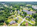Aerial view showcasing homes near a tranquil pond, offering a blend of residential and natural beauty at 11 Chad Ct, Mcdonough, GA 30253