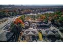 Community aerial view of townhouse complex with mature trees and ample parking, city skyline in the distance at 405 Brighton Pt, Atlanta, GA 30328