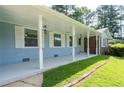 Inviting covered front porch with white pillars and classic lighting fixtures at 4094 Colgate Way, Decatur, GA 30034