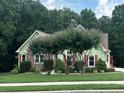 Charming home with red shutters, stone facade, and mature landscaping at 4185 Lenox Park Dr, Buford, GA 30519